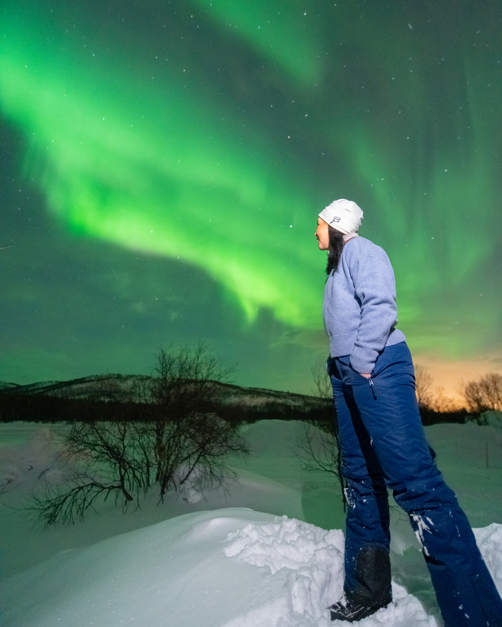 woman watching northern lights kirkenes norway