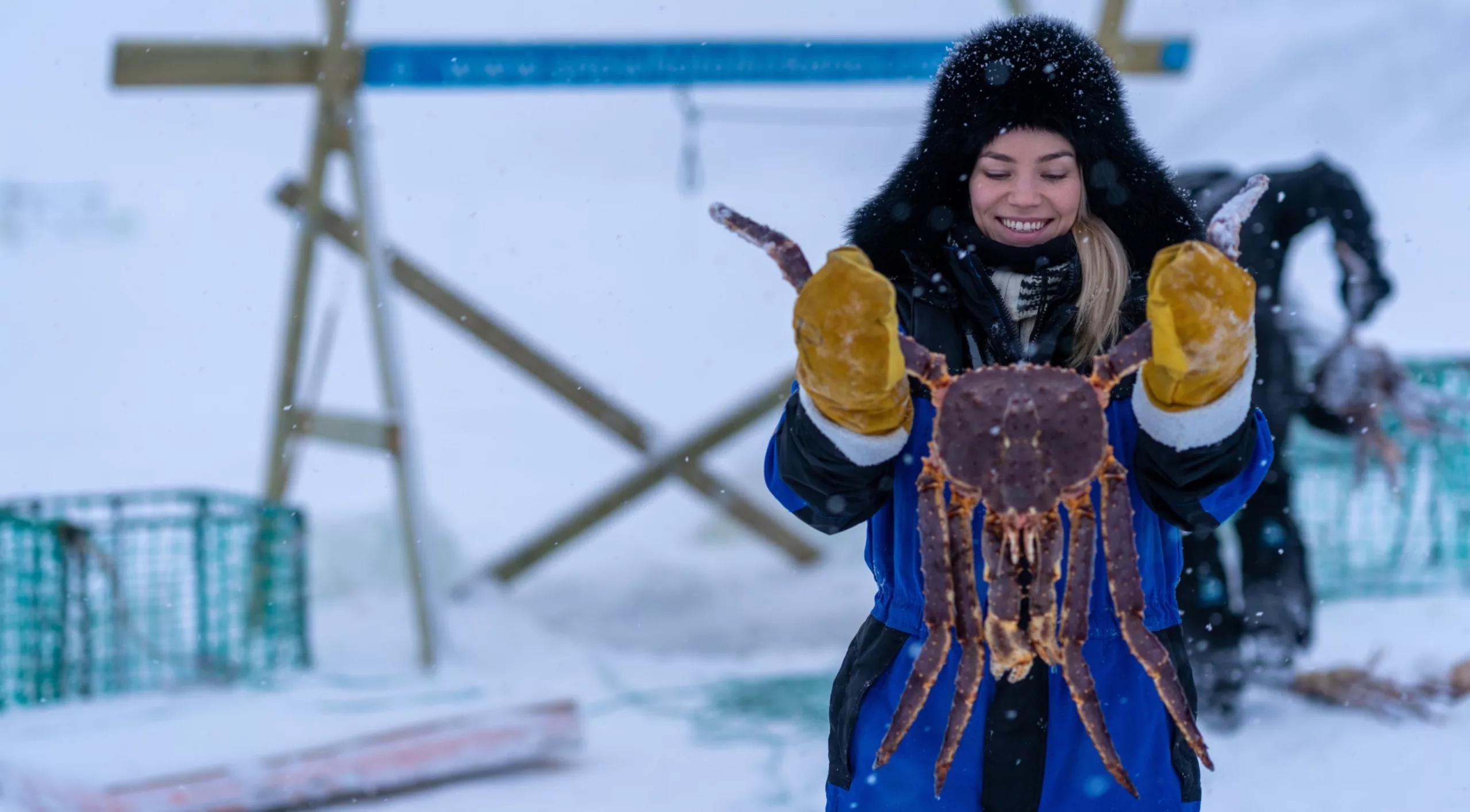 woman posing with king crab on a tour i kirkenes